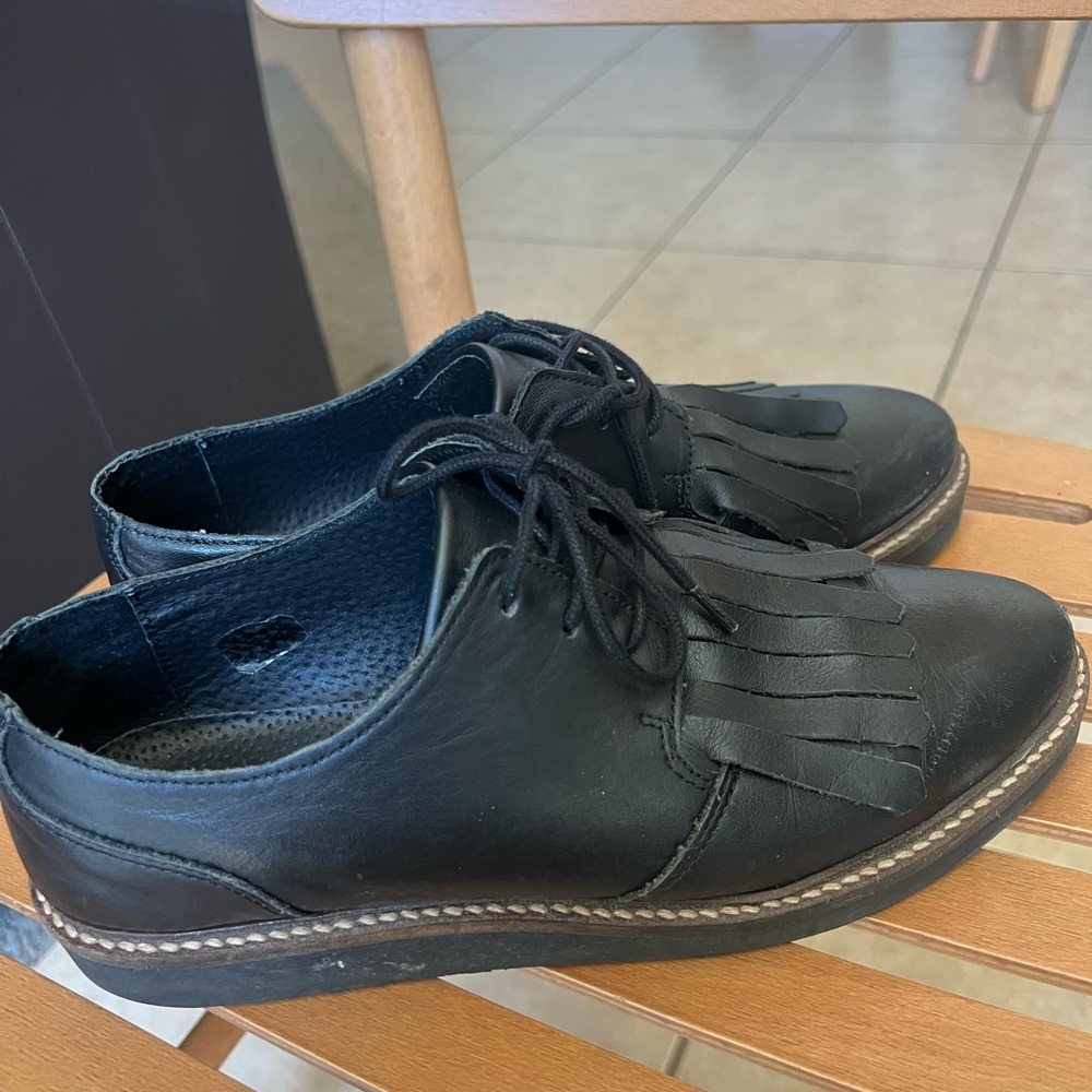 Black loafers with tassels